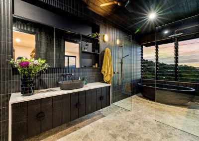 Dark interior bathroom design utilising Breezway Louvre Windows