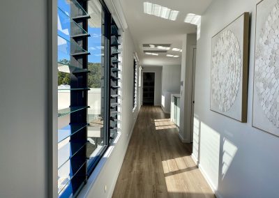 Hallway inside La Casa Eden Display Home featuring Breezway Louvres