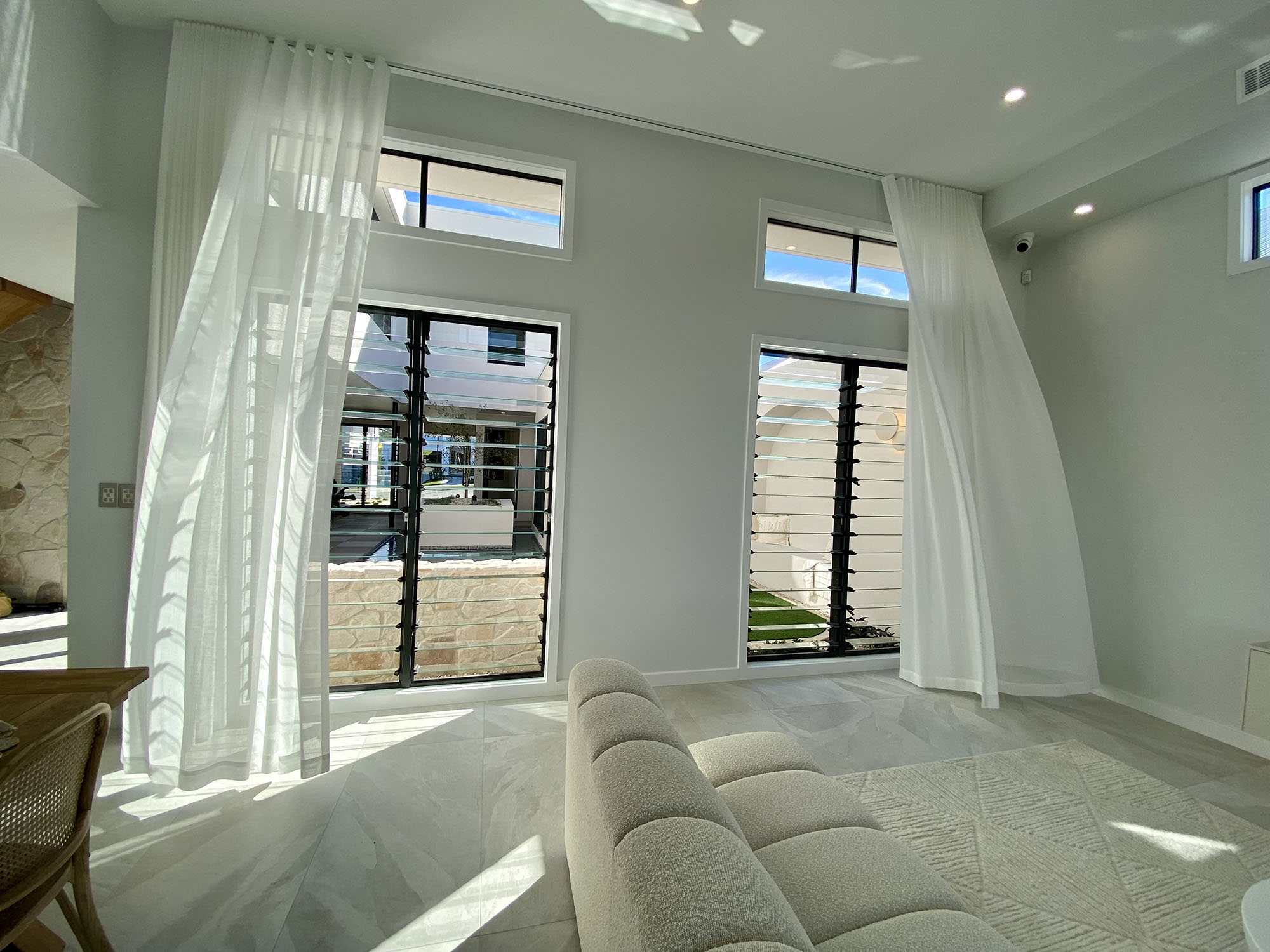 Naturally ventilated living room with Breezway Louvres inside the Ultra Living La Casa Eden Display Home